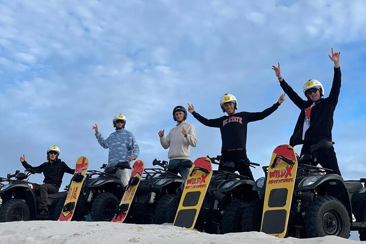 Experience the excitement of quad biking and sandboarding at Atlantis Dunes where endless sandy slopes meet a stunning coastal landscape perfect for adventure seekers.